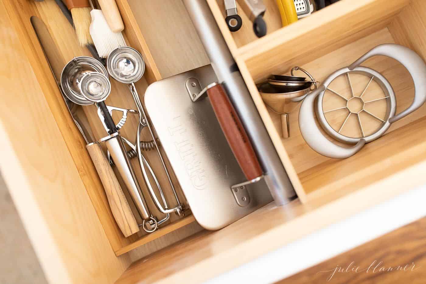 Looking into a drawer full of kitchen drawer inserts with utensils.