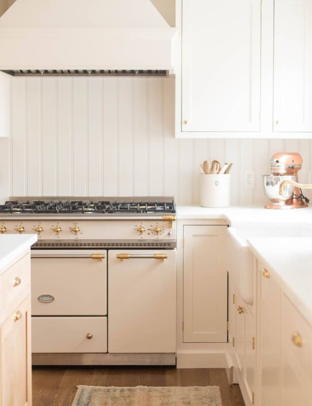 A cream cabinet with an apron front sink.