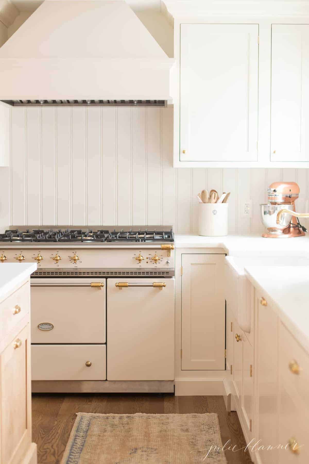 A cream cabinet with an apron front sink.