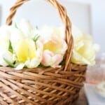A wicker flower basket filled with yellow tulips.