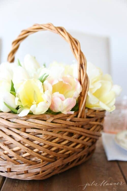 A wicker flower basket filled with yellow tulips.