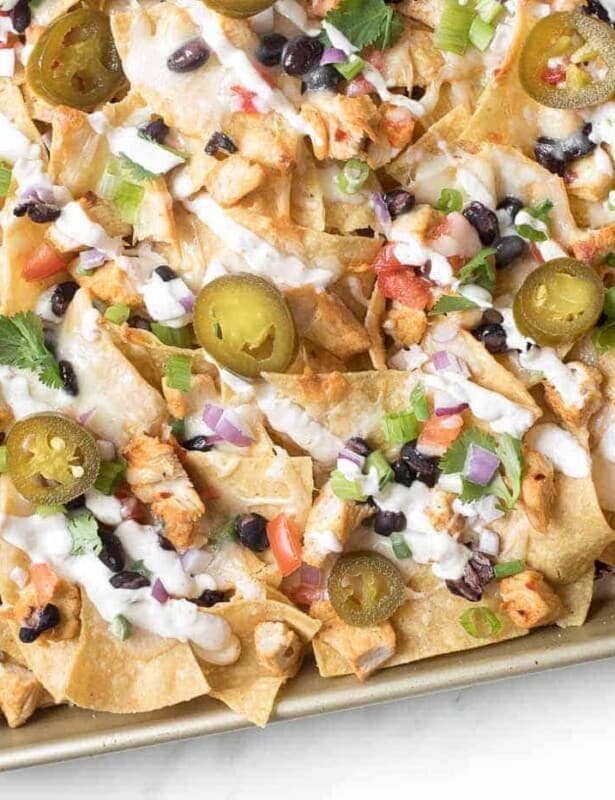 A sheet pan full of delicious chicken nachos for a cinco de mayo menu item