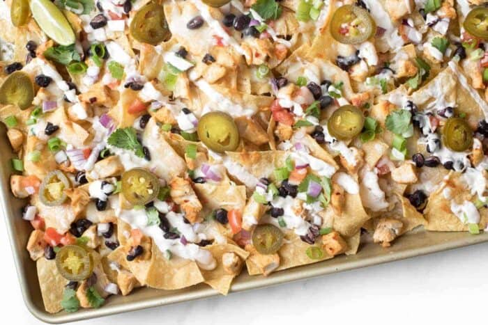 A sheet pan full of delicious chicken nachos for a cinco de mayo menu item