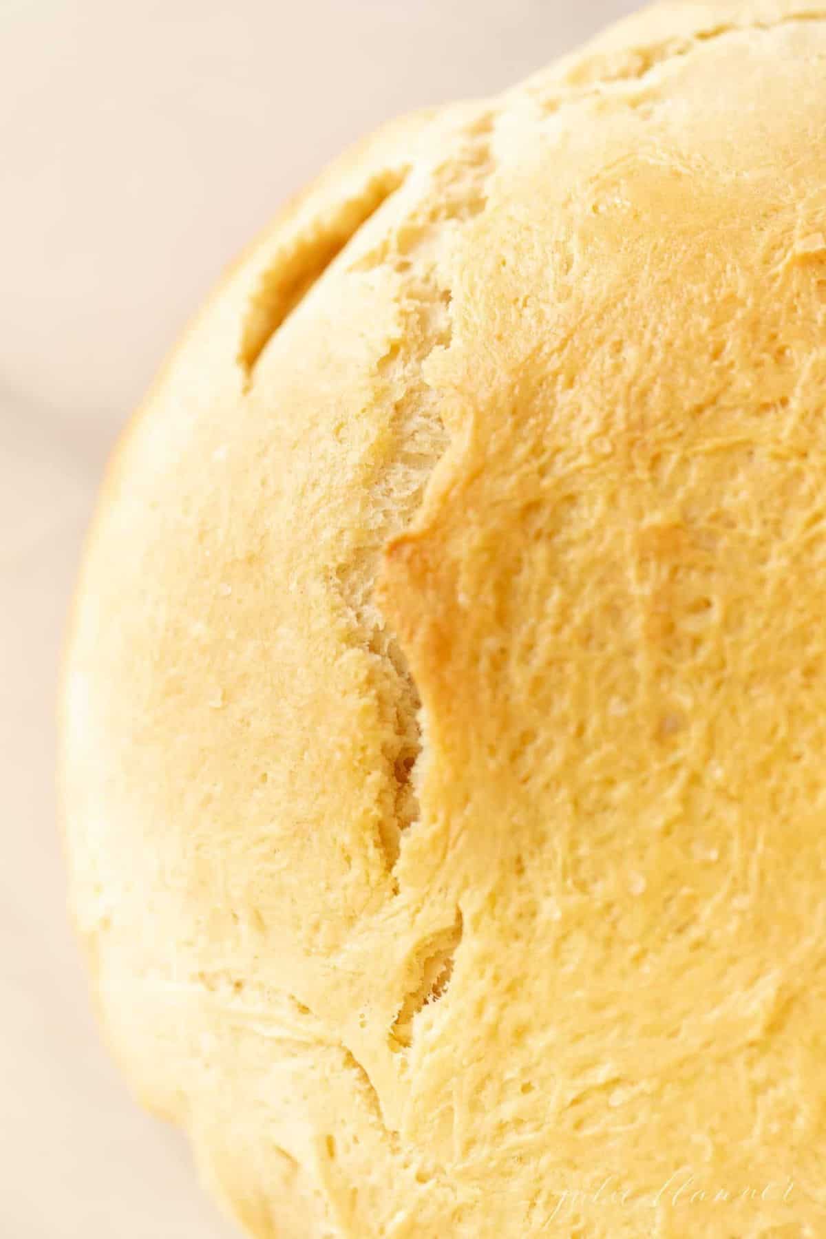 A close up of a round loaf of rosemary olive oil bread.