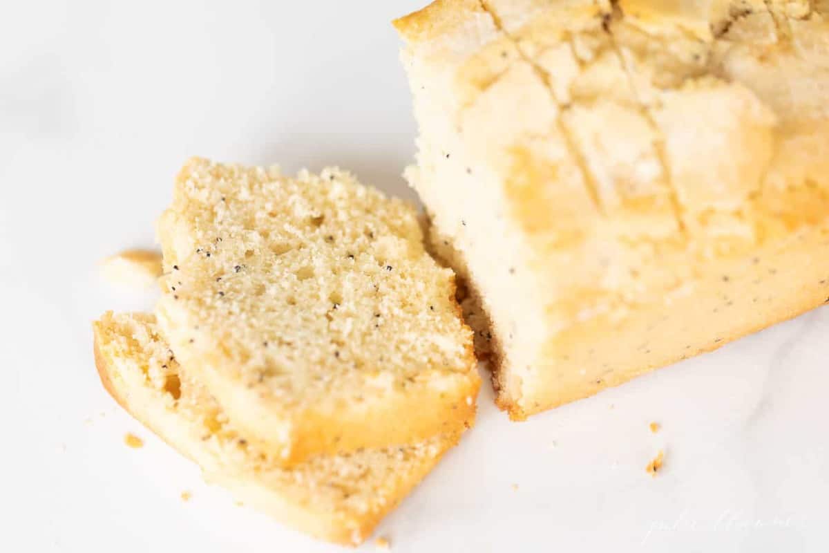 A loaf of fresh baked poppy seed bread, sliced.