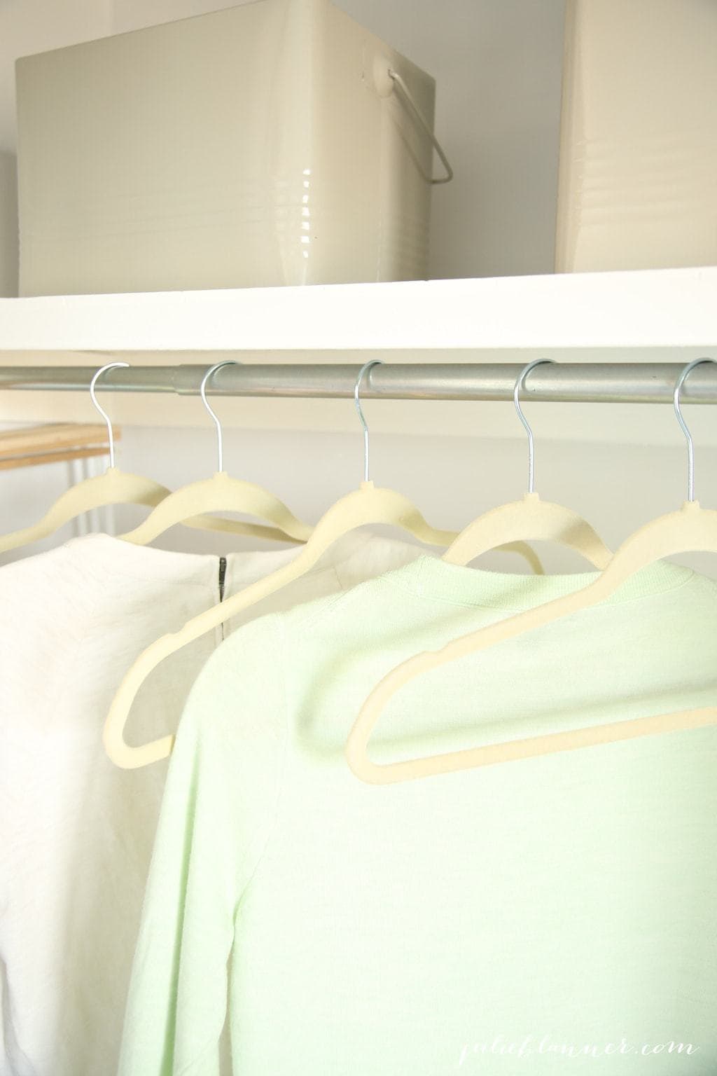 A closet with bins for cleaning supplies and more organization ideas.