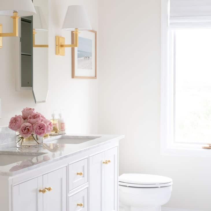 A pretty white bathroom with Benjamin Moore White Dove trim paint.