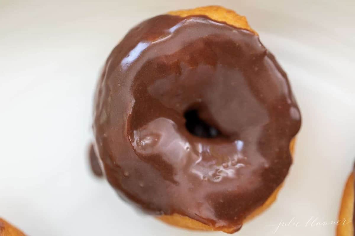 A single donut covered in chocolate for a recipe for easy donuts.