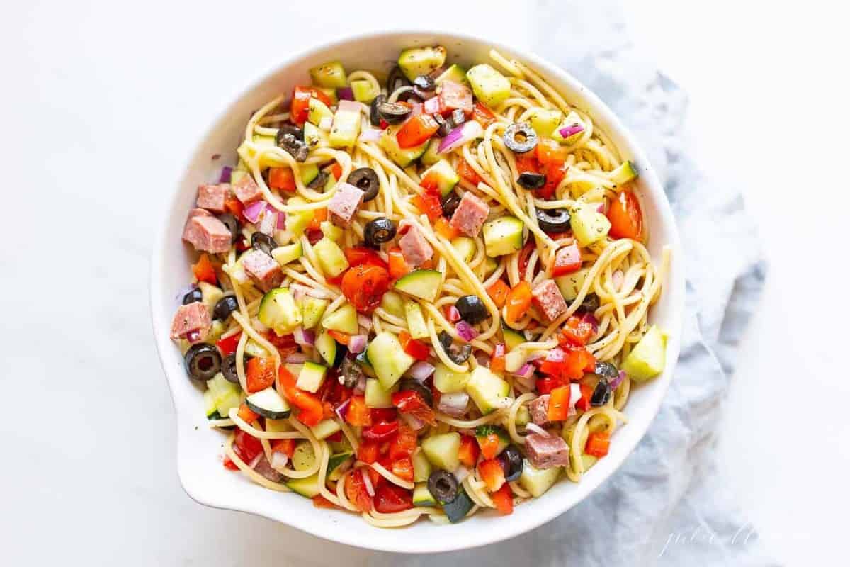 A white bowl full of homemade Italian spaghetti salad.