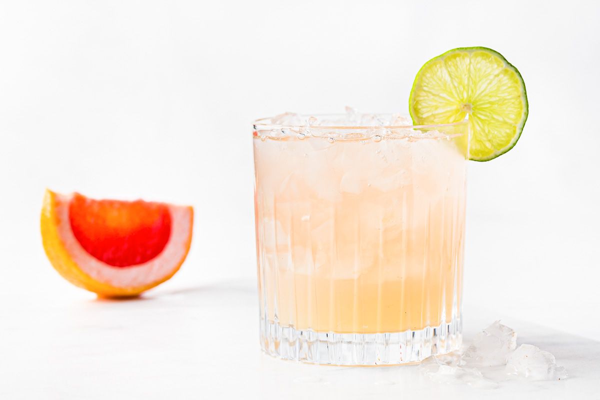 Paloma cocktail in Collins Glass, from tequila with grapefruit juice,  decorated with a slice of grapefruit and rosemary.Whiskey in rocks glass  with i Stock Photo - Alamy