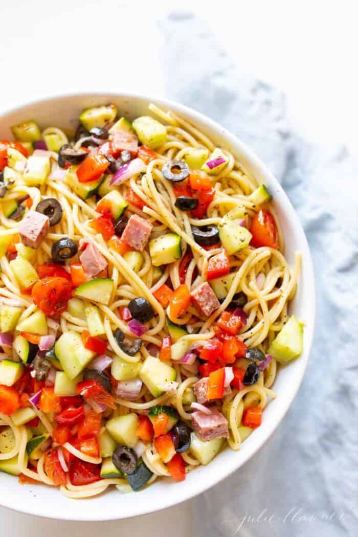 A white bowl full of homemade Italian spaghetti salad.