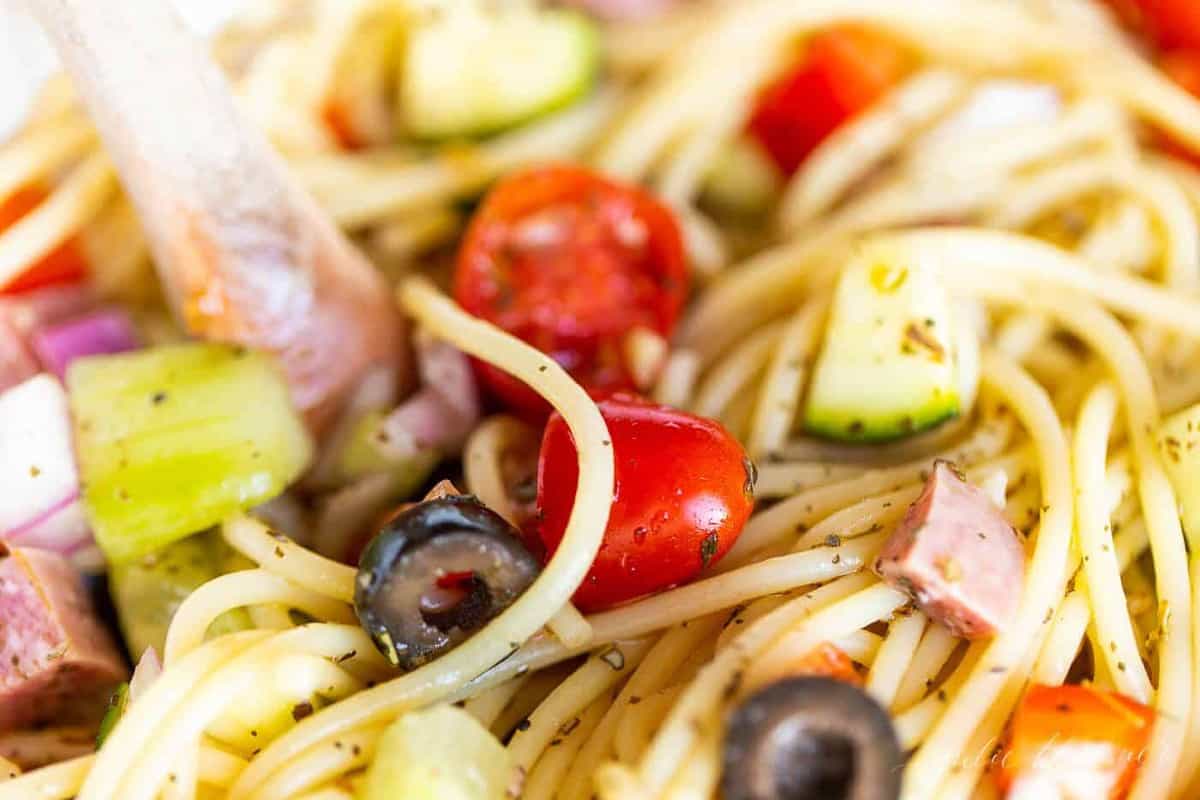 Close up of the veggies in a bowl of spaghetti salad