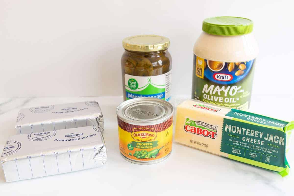 ingredients to make jalapeño dip on white surface