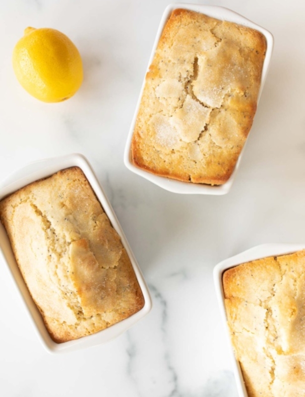 Lemon poppy seed loaves on a marble countertop.