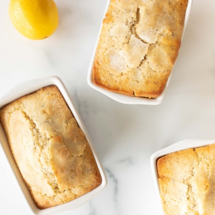 Lemon poppy seed loaves on a marble countertop.