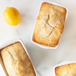 Small lemon poppy seed loaf in white ceramic loaf pans.