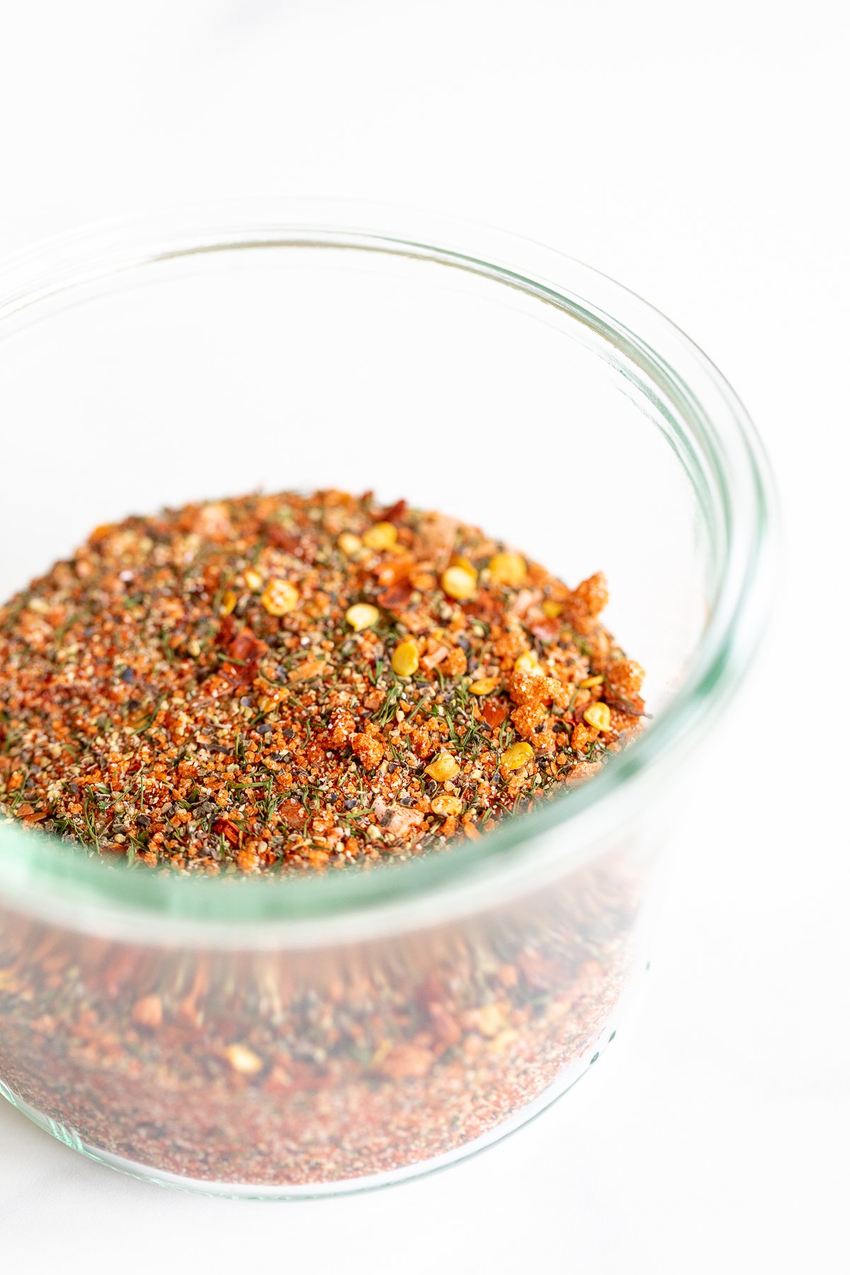 A glass bowl filled with the best steak seasoning mixture.