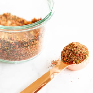 A bowl of the best steak seasoning with a spoon next to it.