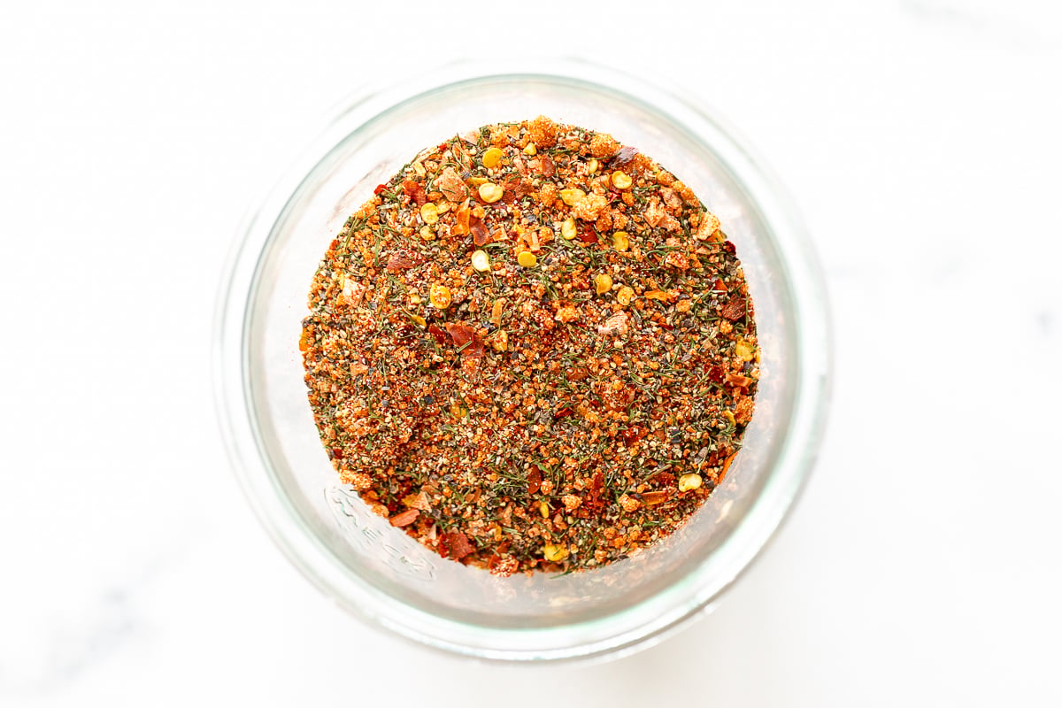 A glass jar with a mixture of the best steak seasoning in it.