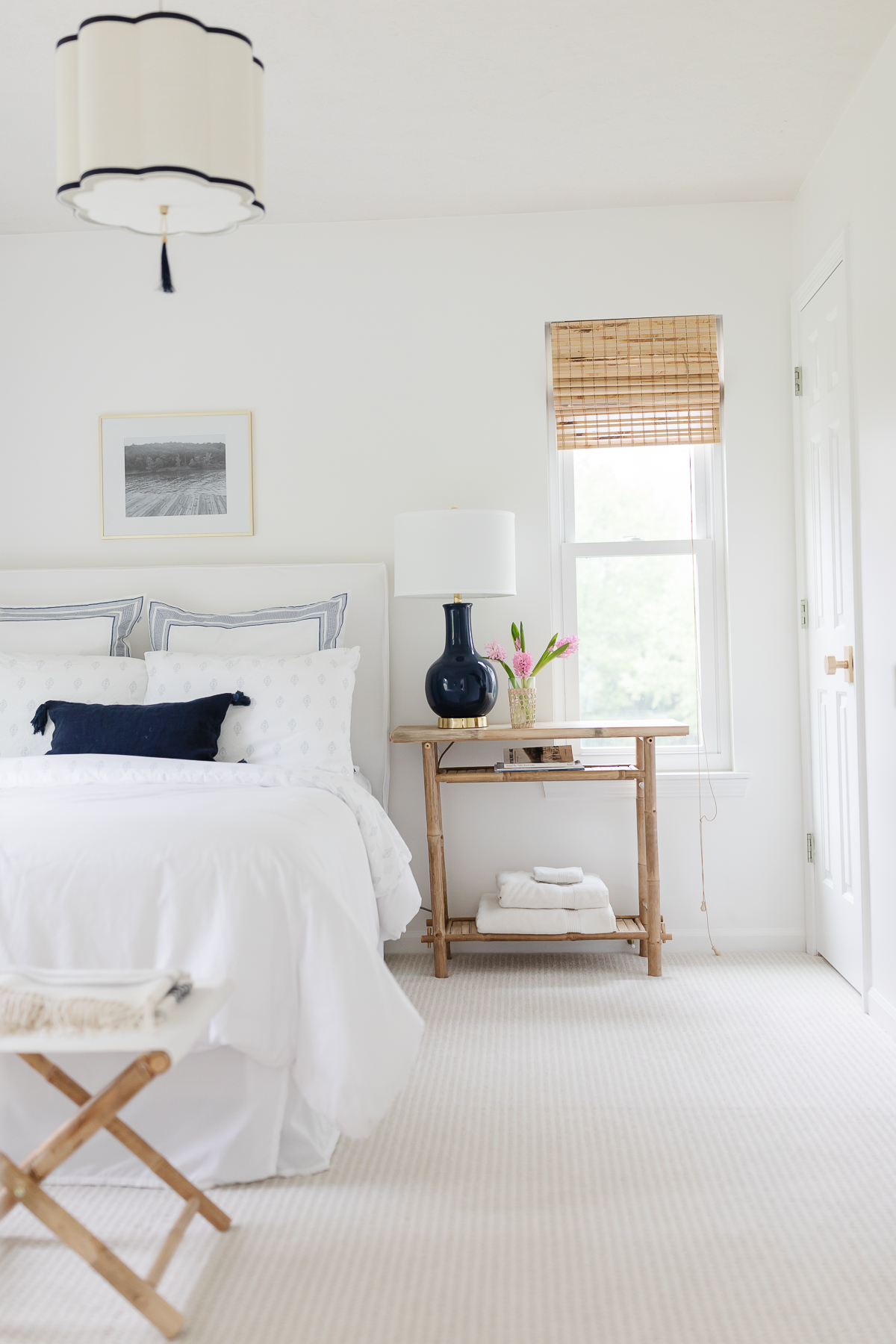 A white bedroom with rattan accents