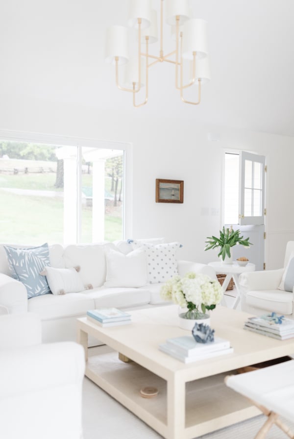 A white living room with white furniture for a vacation vibe at home.
