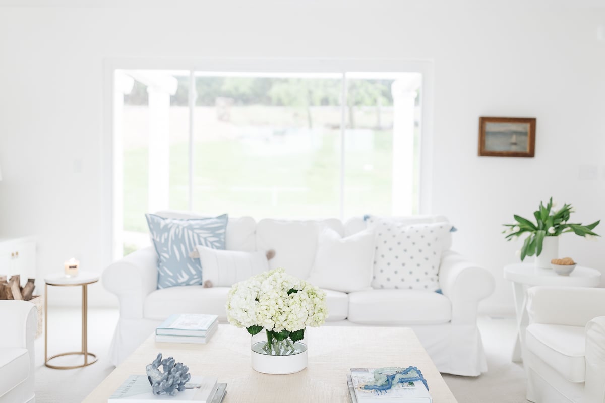 A white living room with white furniture for a vacation vibe at home.