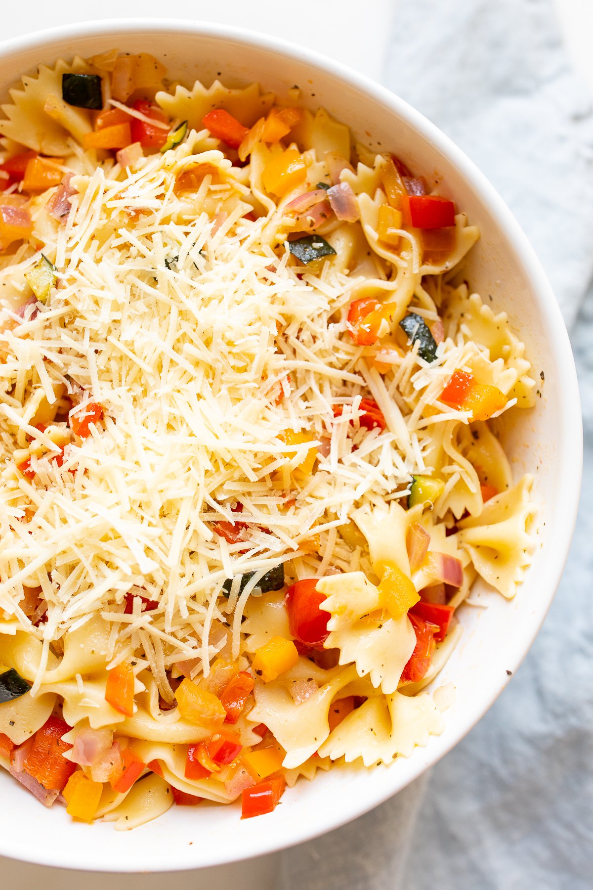 A white bowl full of veggie pasta salad for a side dish for wraps