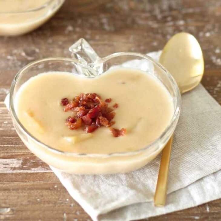 cheese soup topped with bacon in apple shaped dish