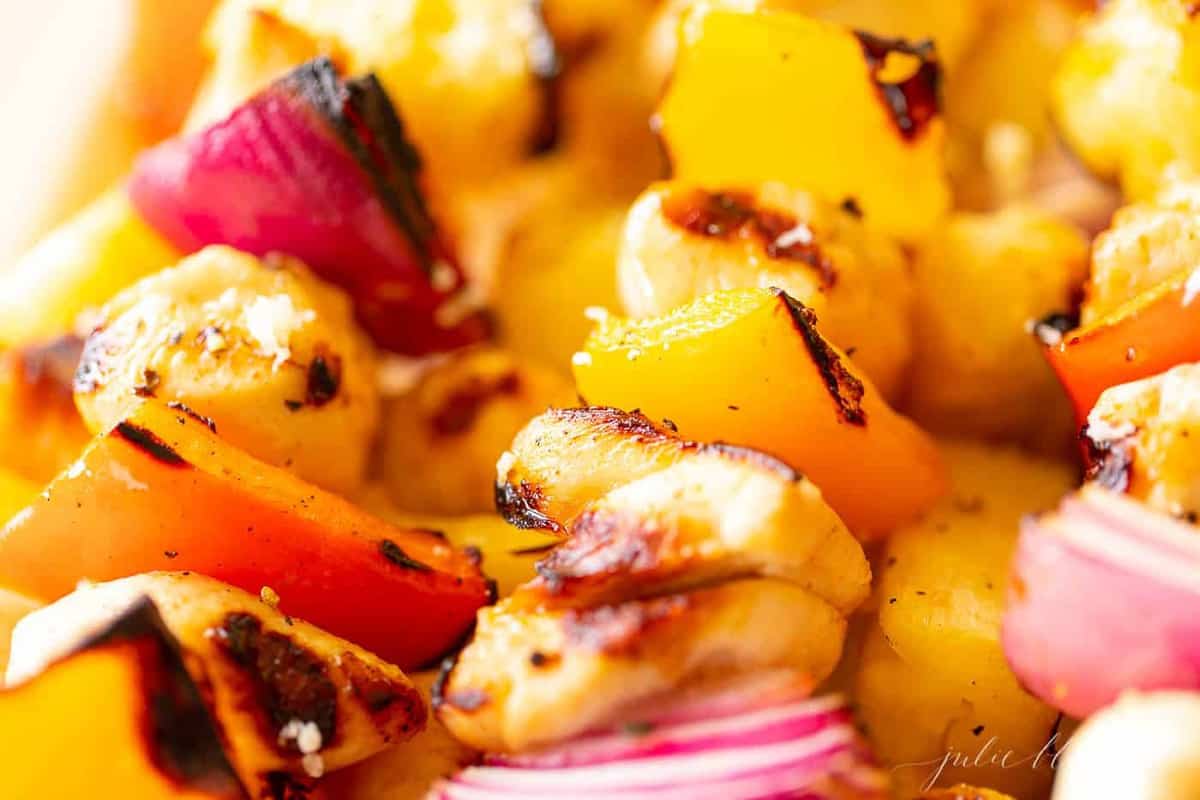 Close up shot of grilled chicken kabobs.