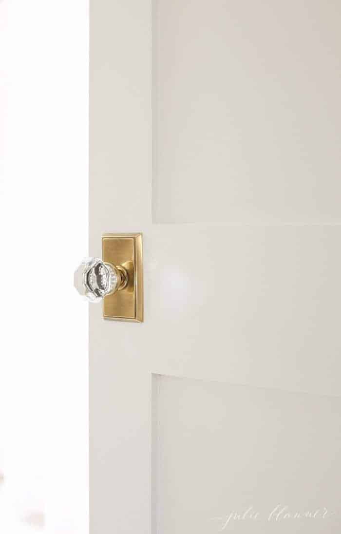 White door with a brass and glass knob.