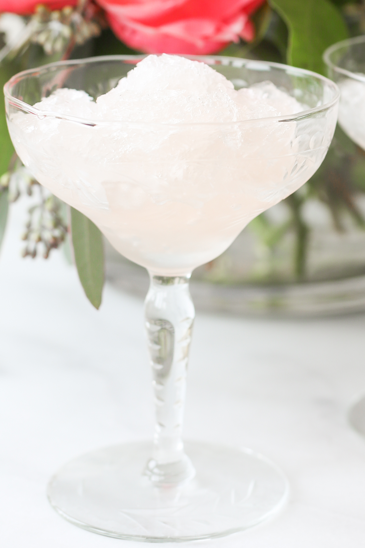 Two martini glasses filled with refreshing frosé, garnished with ice.