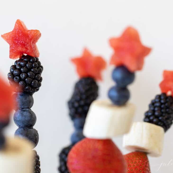 Close up of fourth of july inspired fresh fruit kabobs made of summer berries.