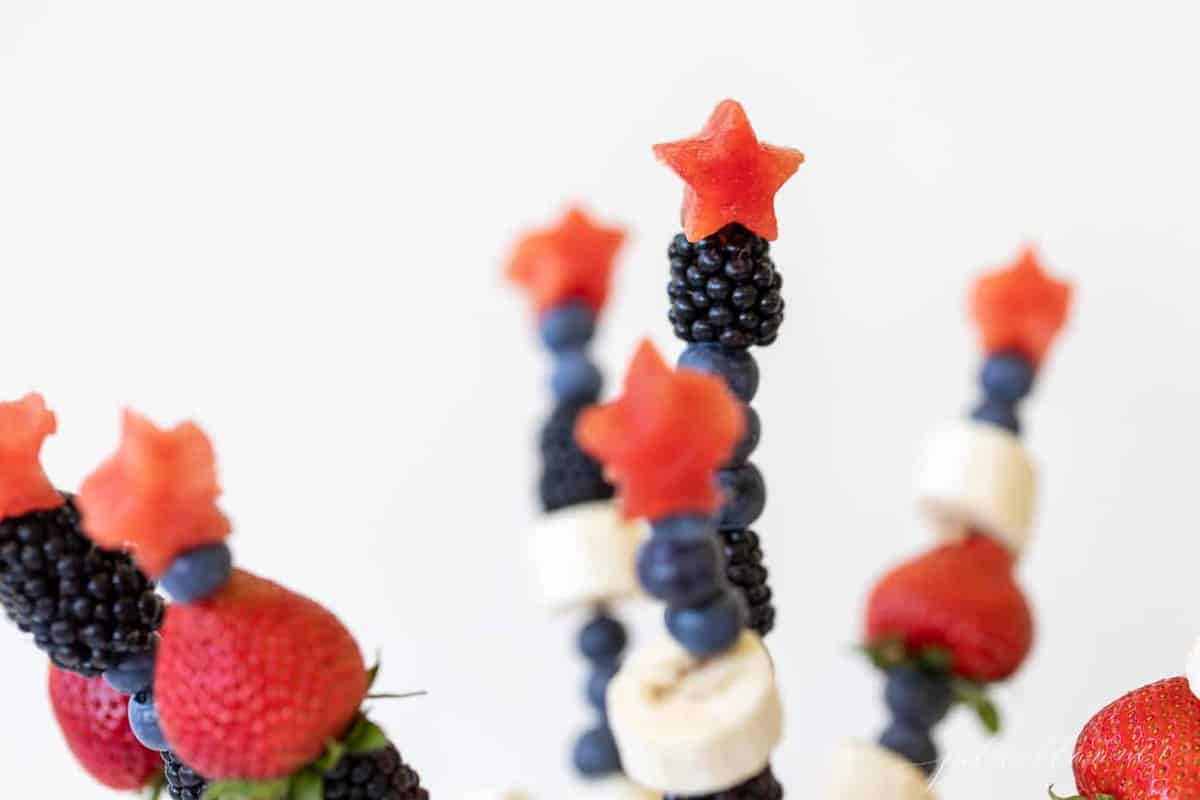Close up of fourth of july inspired fresh fruit kabobs made of summer berries.
