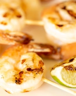 Tequila lime shrimp skewers on a white platter.