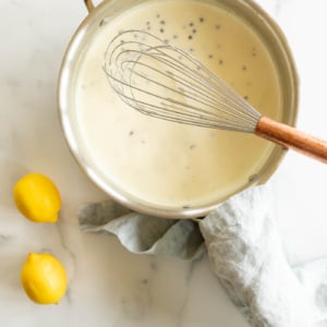 A stainless steel pan filled with a white wine lemon caper sauce.