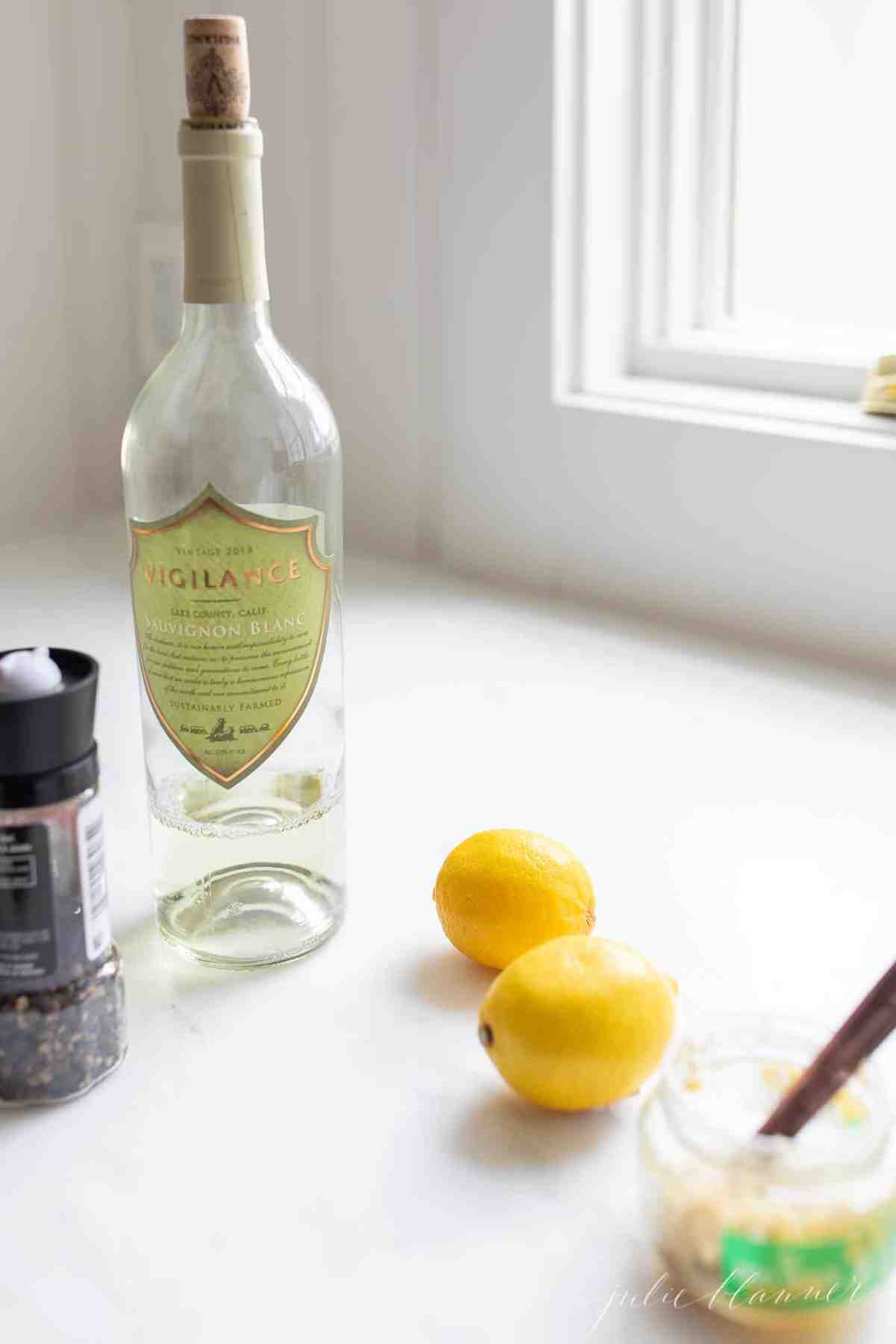 A white kitchen with ingredients for lemon garlic shrimp kabob marinade on the counter.