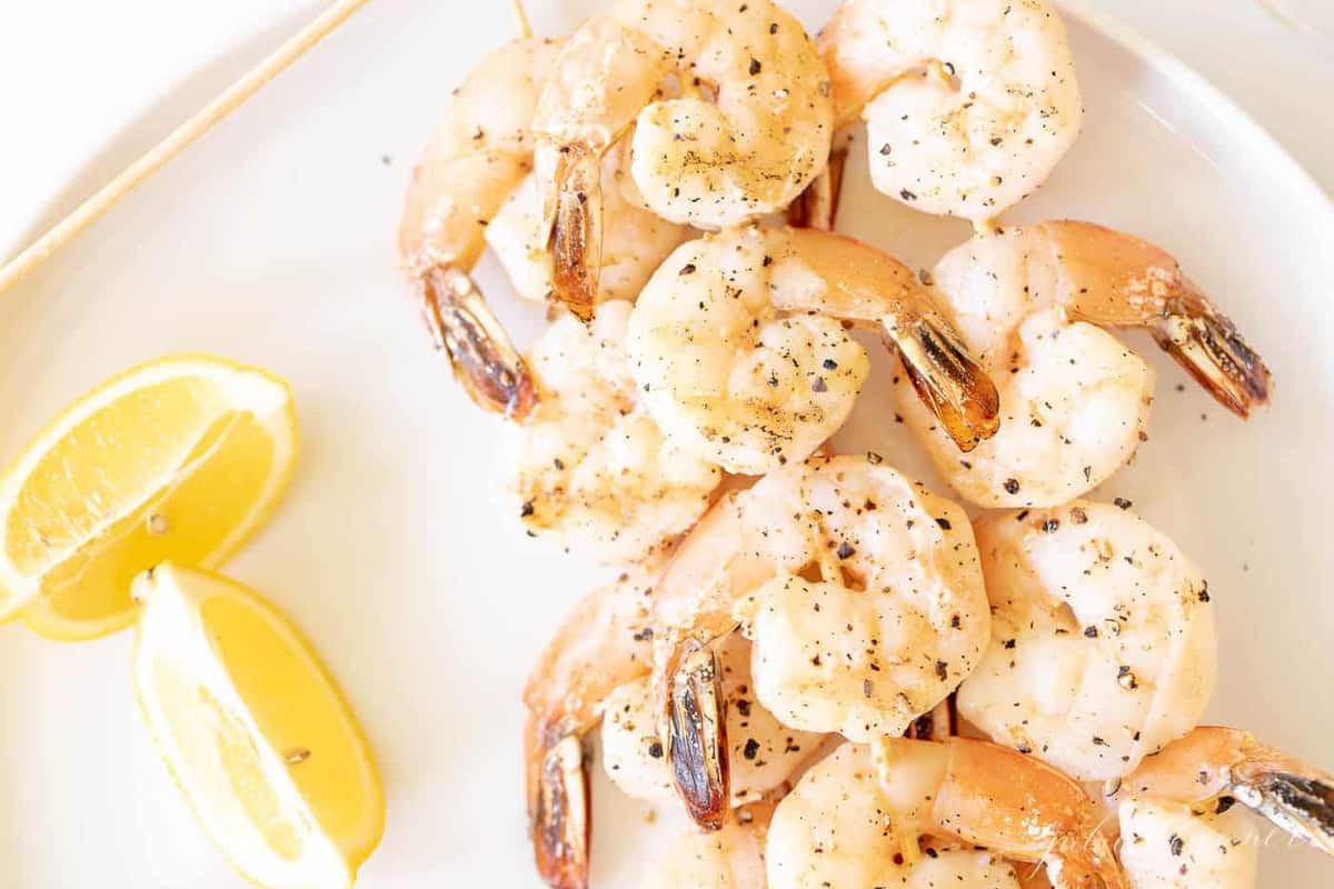 Close up of lemon garlic shrimp kabobs on bamboo skewers.