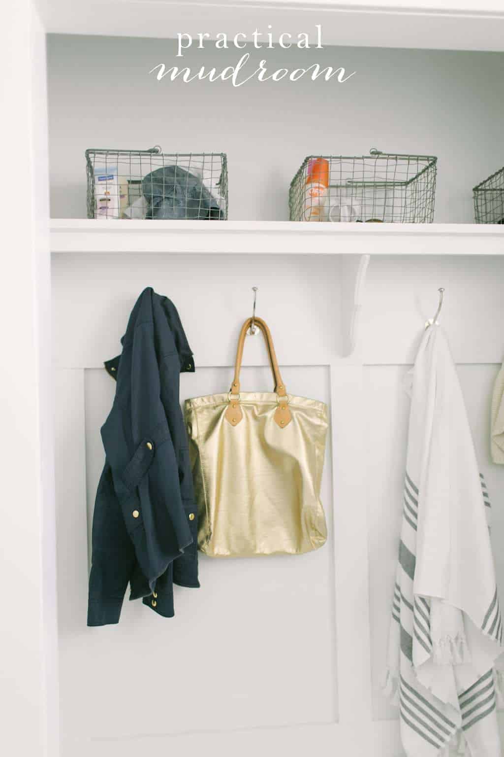 A mudroom with baskets and coats hanging from farmhouse hooks.