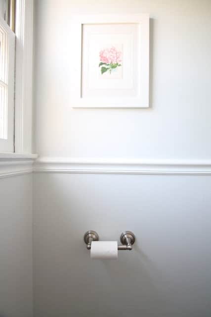 A bathroom painted in SW Rhinestone, pedestal sink in foreground.