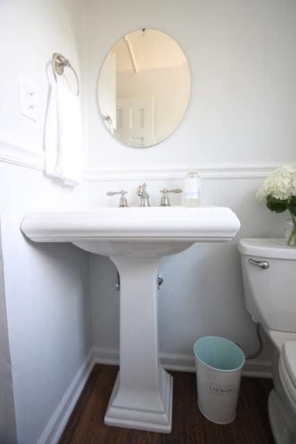 A bathroom painted in SW Rhinestone, pedestal sink in foreground.