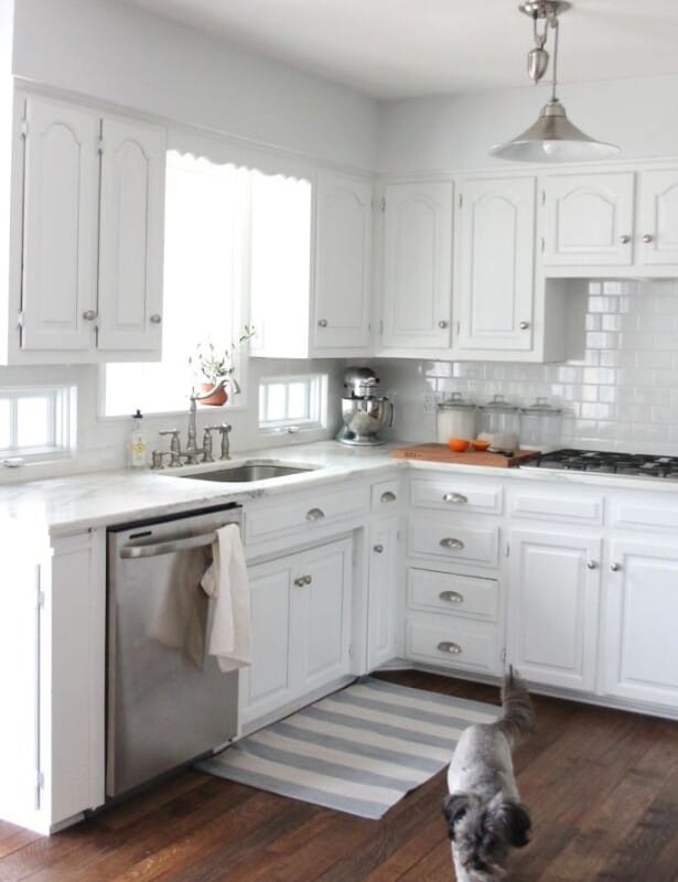 An all white kitchen with walls painted Sherwin Williams Rhinestone.