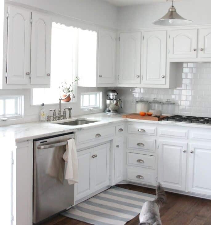 An all white kitchen with walls painted Sherwin Williams Rhinestone.