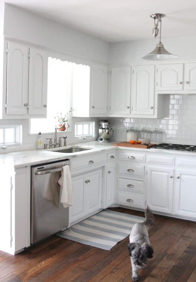 An all white kitchen with walls painted Sherwin Williams Rhinestone.