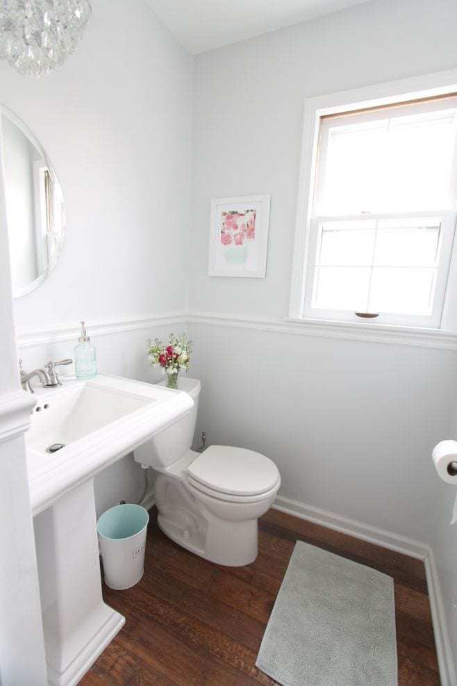 A white bathroom with walls painted in Sherwin Williams Rhinestone.