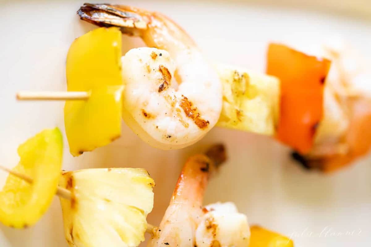 Close up shot of pineapple shrimp recipe on bamboo skewers.