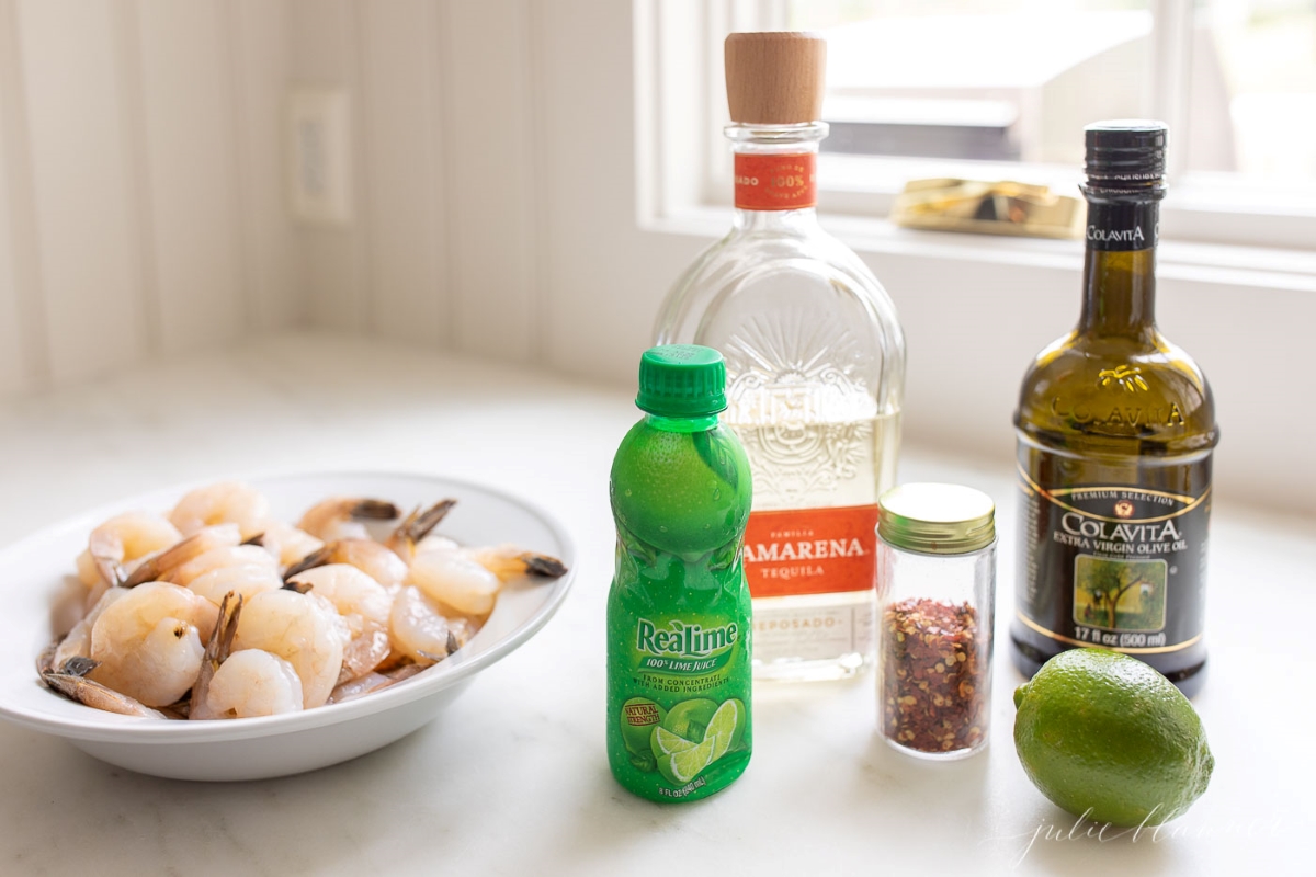 Ingredients for tequila lime shrimp on a white countertop