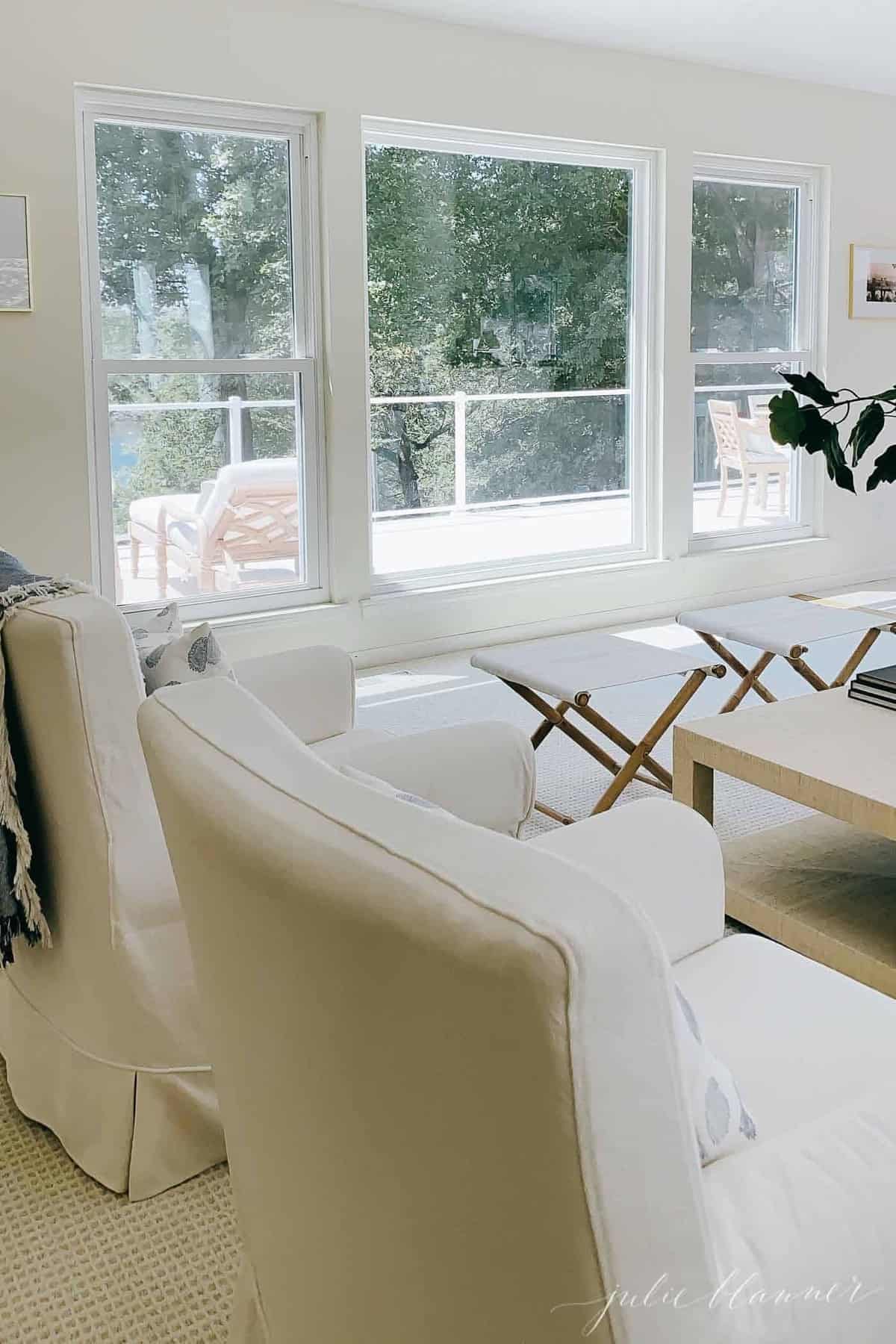 View of a white vinyl deck through large living room windows.