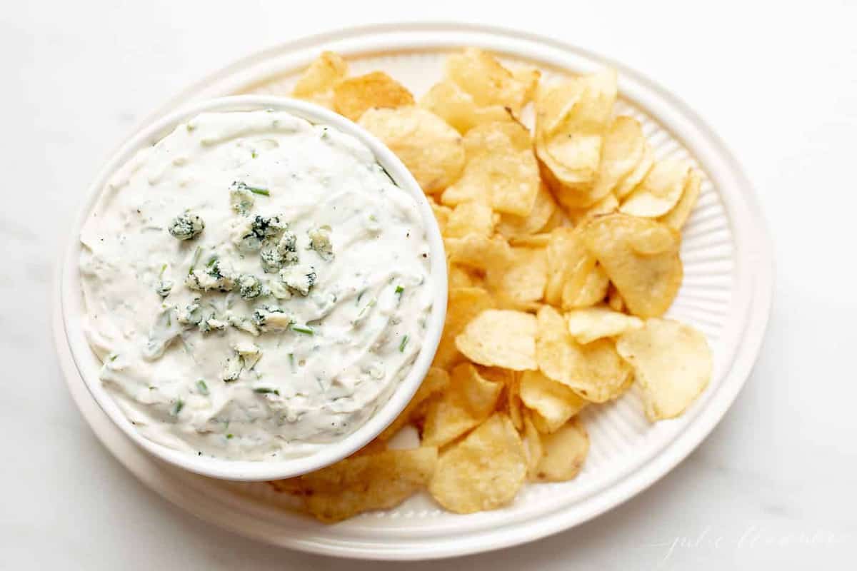 blue cheese dip in bowl on platter with chips