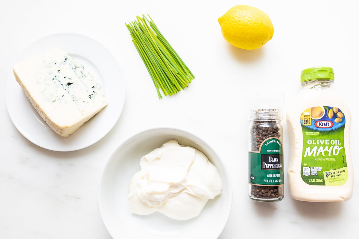 Ingredients for blue cheese dip on a white countertop.