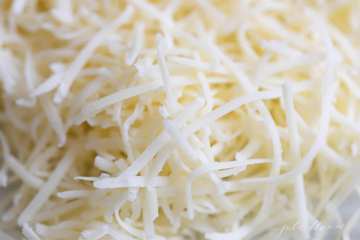 Freshly shredded white cheddar cheese.